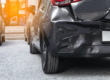 Damaged Rear End Bumper Of Black Car from Car Accident Needs Paintless Dent Repair Service