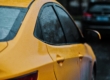 Yellow car getting rained on