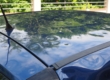 Blue car with hail dents in the roof from Colorado Hailstorms & Hail Damage Repair