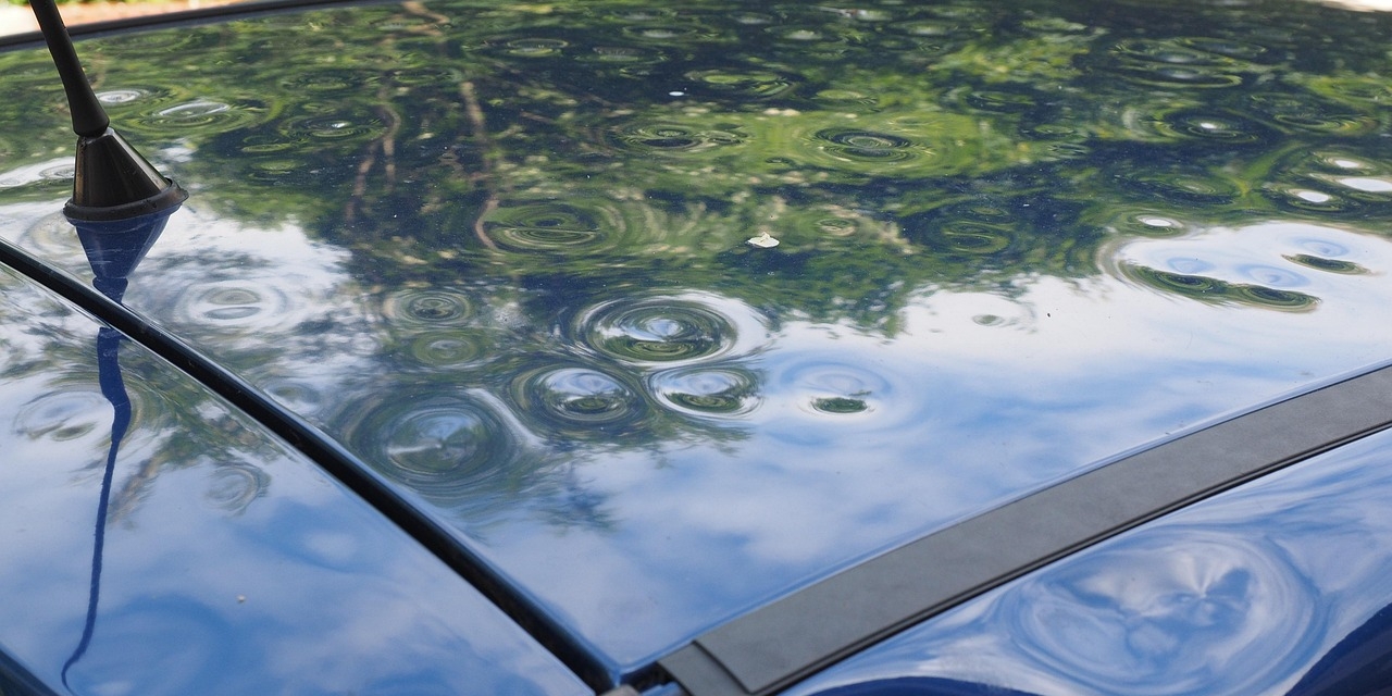 colorado-hail-damage-repairjpg Blue car with hail dents in the roof from Colorado Hailstorms & Hail Damage Repair